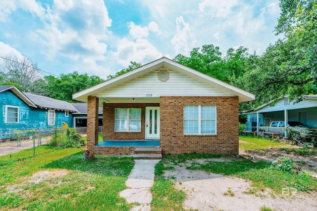 bungalow-style home with a porch and a front yard