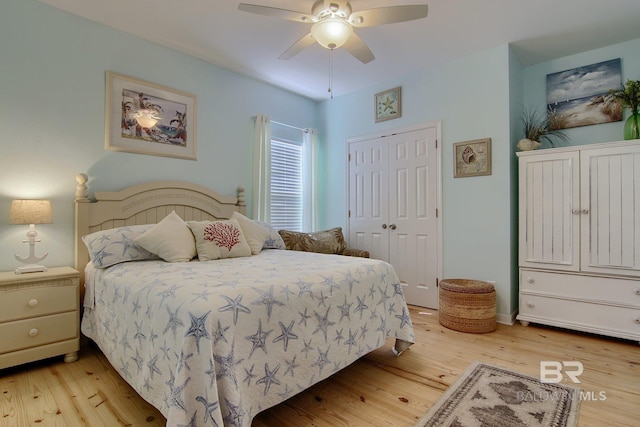 bedroom with a closet, ceiling fan, and light wood-style flooring