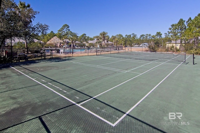 view of sport court with fence