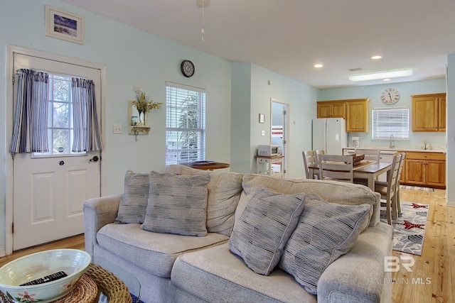 living area featuring light wood finished floors and recessed lighting