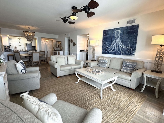 living room featuring wood-type flooring and ceiling fan