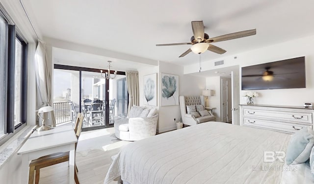 bedroom with light hardwood / wood-style flooring, ceiling fan with notable chandelier, and access to outside