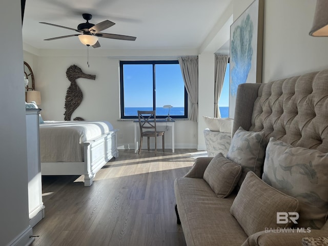 bedroom with dark hardwood / wood-style floors and ceiling fan