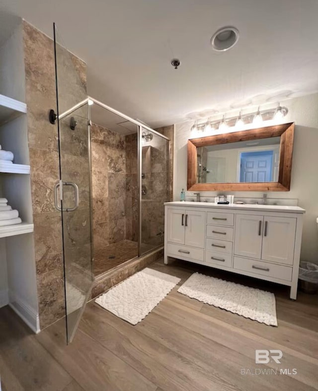 bathroom with vanity, hardwood / wood-style floors, and walk in shower