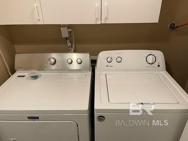 washroom featuring cabinets and washer and dryer