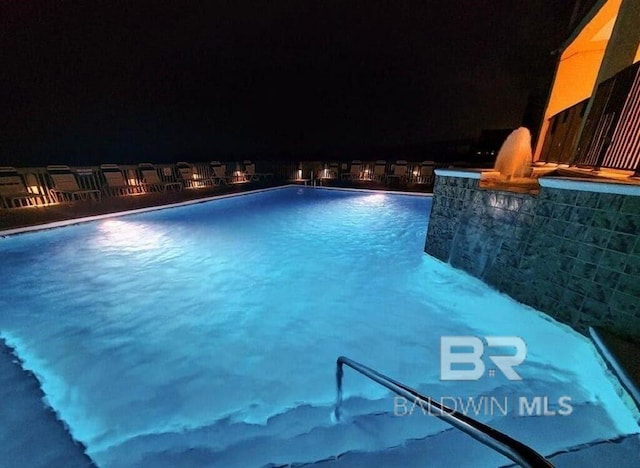 view of pool at night