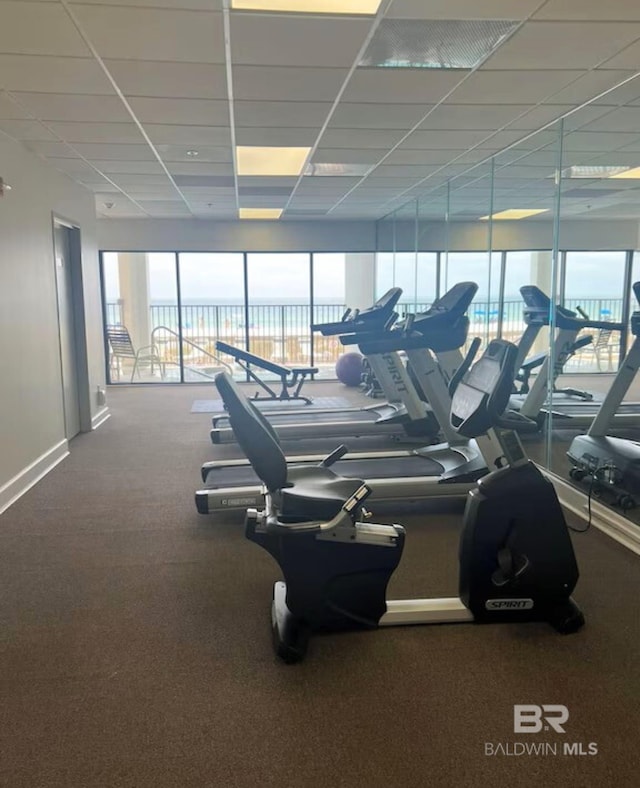 exercise room featuring a paneled ceiling