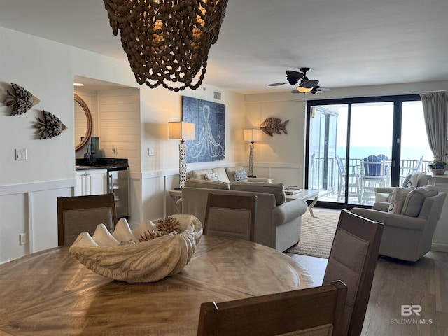 dining room with hardwood / wood-style flooring and ceiling fan