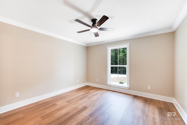 unfurnished room with crown molding, light wood-style flooring, ceiling fan, and baseboards