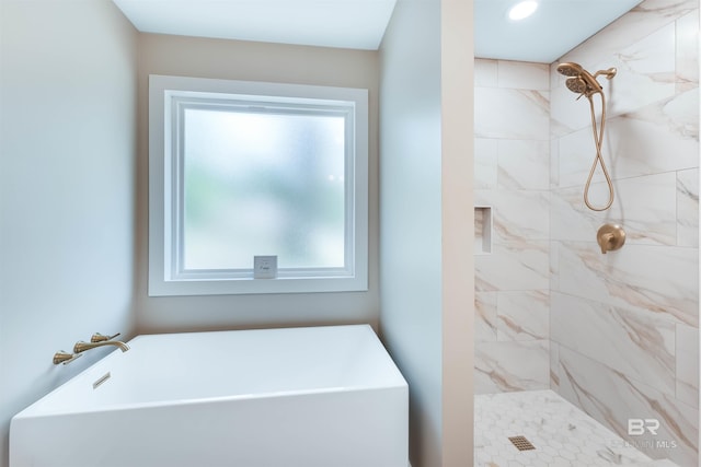 full bathroom featuring a tile shower and a soaking tub