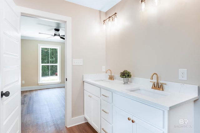 full bathroom featuring baseboards, a sink, ceiling fan, and wood finished floors