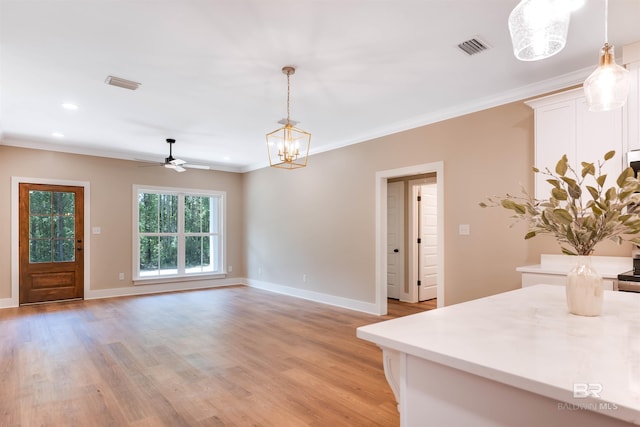 dining room featuring baseboards, visible vents, light wood-style flooring, and ceiling fan with notable chandelier