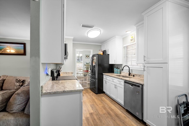 kitchen with white cabinetry, sink, black appliances, light hardwood / wood-style flooring, and crown molding