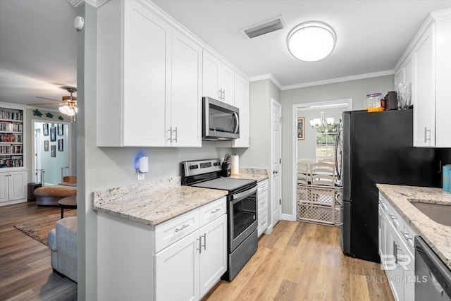 kitchen featuring stainless steel appliances, light stone counters, crown molding, white cabinetry, and light wood-type flooring