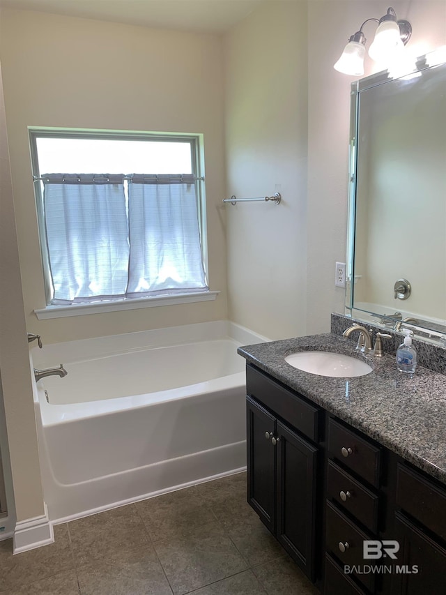 bathroom featuring vanity, a tub to relax in, and tile patterned flooring