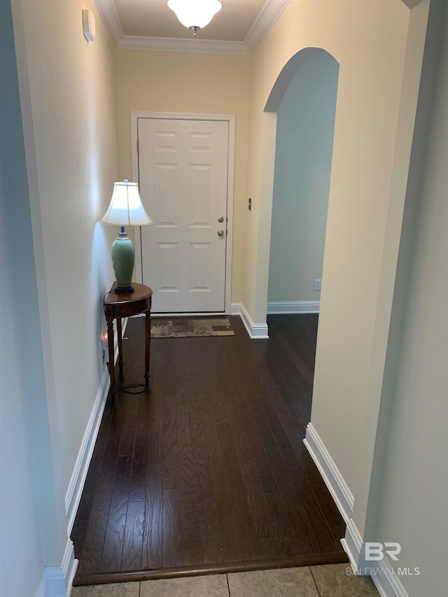 doorway to outside featuring crown molding and hardwood / wood-style flooring