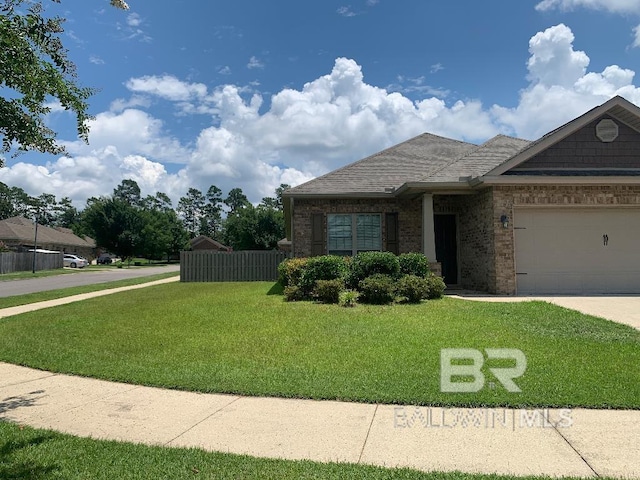 view of front of property with a garage and a front lawn