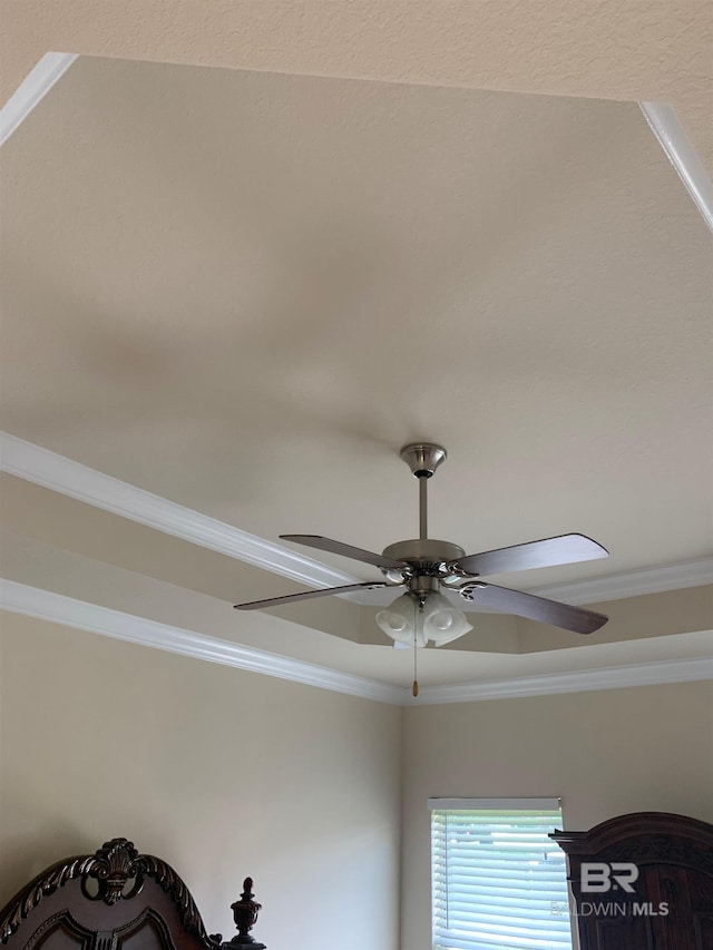 interior details with crown molding and ceiling fan