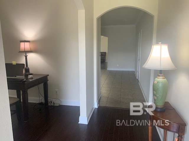 hall featuring hardwood / wood-style flooring and crown molding