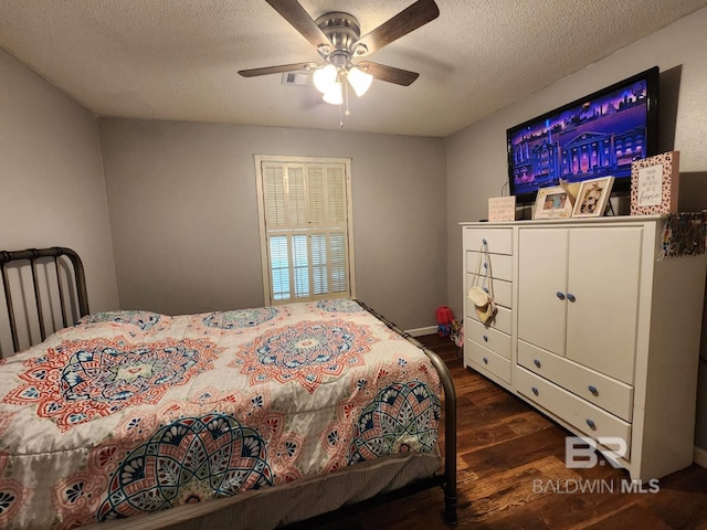 bedroom with a textured ceiling, a ceiling fan, and wood finished floors