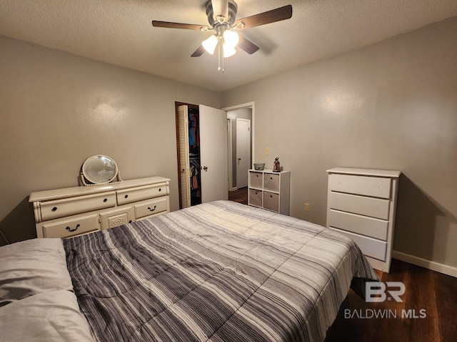 bedroom with dark wood-type flooring, ceiling fan, a textured ceiling, and baseboards