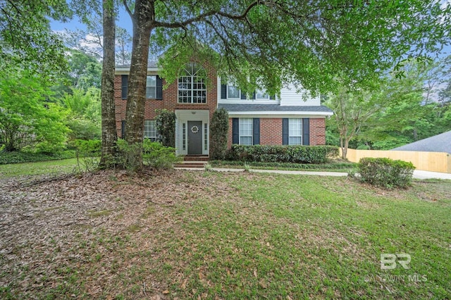 7750 Charleston Oaks Dr, Daphne, AL 36526 - colonial house with brick siding, fence, and a front yard