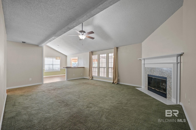7750 Charleston Oaks Dr, Daphne, AL 36526 - unfurnished living room featuring ceiling fan, a fireplace, a textured ceiling, carpet, and vaulted ceiling with beams