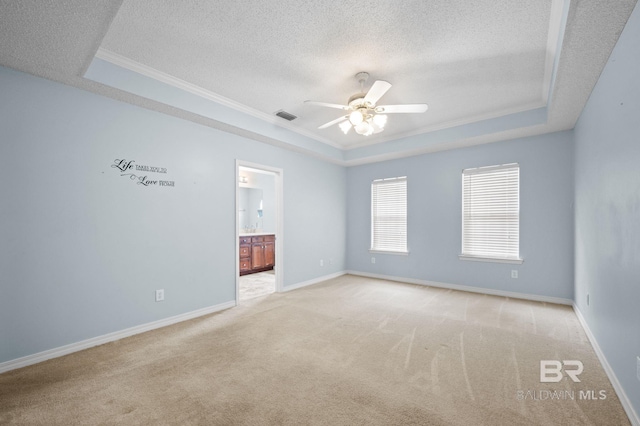 7750 Charleston Oaks Dr, Daphne, AL 36526 - carpeted spare room with ornamental molding, a textured ceiling, a ceiling fan, and a tray ceiling