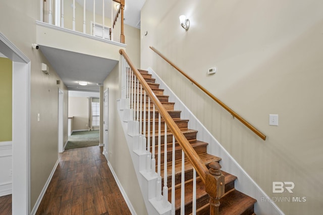 7750 Charleston Oaks Dr, Daphne, AL 36526 - staircase with baseboards, a towering ceiling, and hardwood / wood-style floors