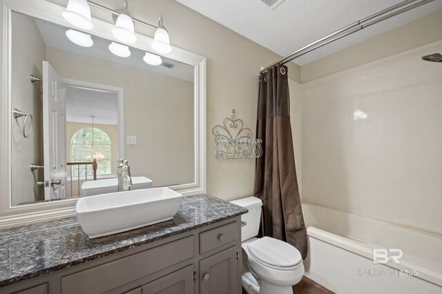 7750 Charleston Oaks Dr, Daphne, AL 36526 - bathroom with vanity, toilet, a textured ceiling, and shower / bath combo with shower curtain
