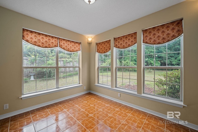 7750 Charleston Oaks Dr, Daphne, AL 36526 - spare room with baseboards, a textured ceiling, and a wealth of natural light