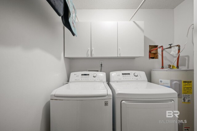 7750 Charleston Oaks Dr, Daphne, AL 36526 - laundry area featuring water heater, cabinet space, and washer and dryer
