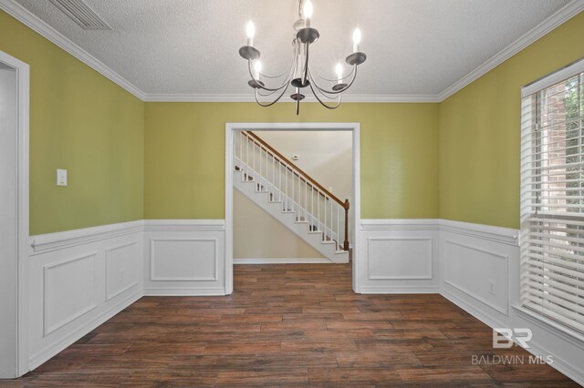 7750 Charleston Oaks Dr, Daphne, AL 36526 - spare room featuring stairs, an inviting chandelier, wood finished floors, and a wainscoted wall