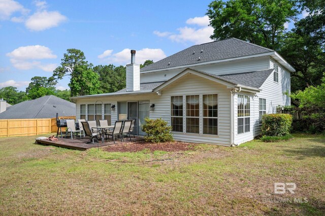 7750 Charleston Oaks Dr, Daphne, AL 36526 - rear view of property with fence, roof with shingles, a wooden deck, a chimney, and a lawn