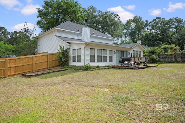 7750 Charleston Oaks Dr, Daphne, AL 36526 - rear view of property featuring a shingled roof, a wooden deck, a fenced backyard, a chimney, and a lawn