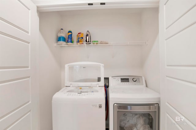 washroom with washing machine and clothes dryer