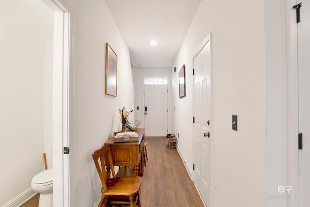 corridor with hardwood / wood-style flooring