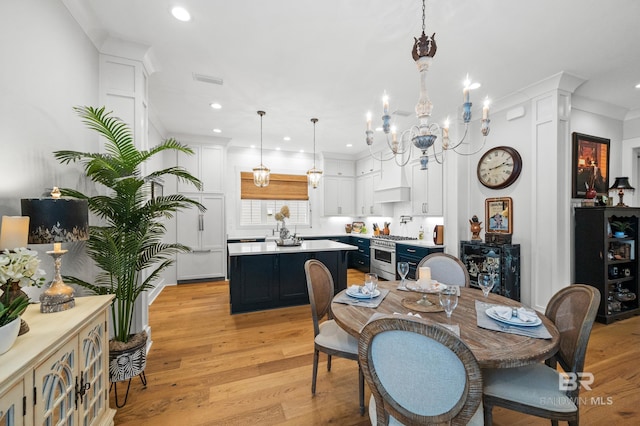 dining area featuring light wood-type flooring and an inviting chandelier