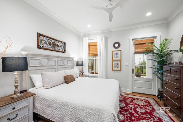 bedroom featuring ceiling fan, light hardwood / wood-style floors, and ornamental molding