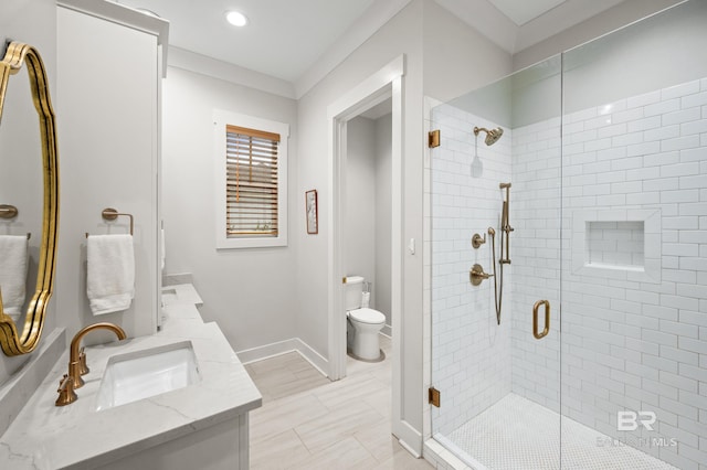 bathroom with vanity, toilet, and a shower with shower door