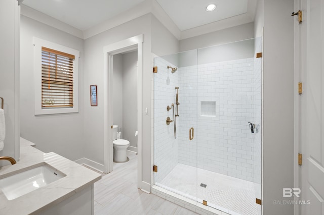 bathroom with an enclosed shower, vanity, and toilet