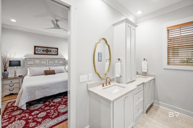 bathroom with hardwood / wood-style floors, vanity, and ceiling fan