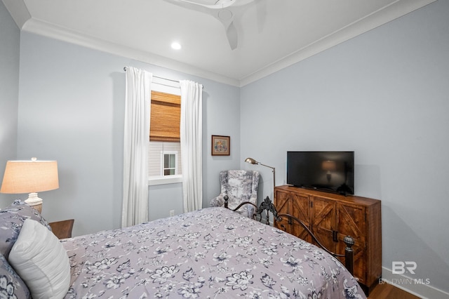 bedroom with ceiling fan, crown molding, and hardwood / wood-style flooring