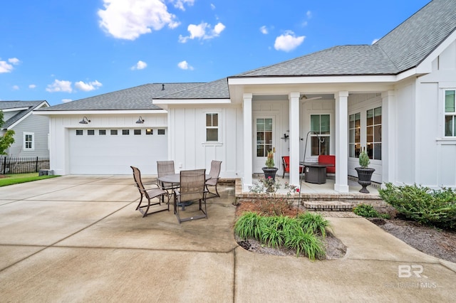 exterior space with covered porch and a garage