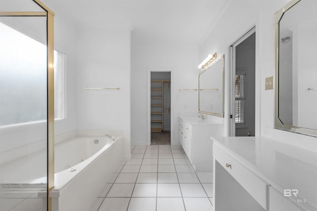 bathroom featuring tile patterned flooring, a tub to relax in, crown molding, and vanity