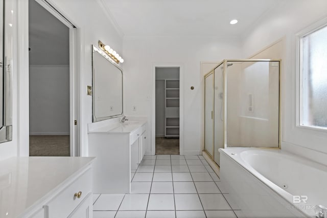 bathroom with tile patterned flooring, shower with separate bathtub, a wealth of natural light, and vanity