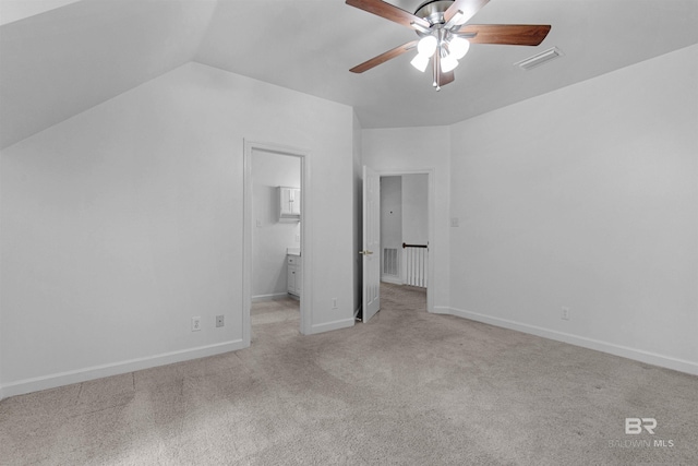 unfurnished bedroom with vaulted ceiling, light colored carpet, and ceiling fan