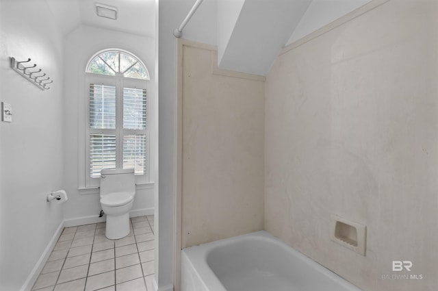 bathroom featuring a bath, lofted ceiling, a wealth of natural light, and tile patterned floors