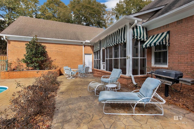 view of patio featuring grilling area, a sunroom, and french doors