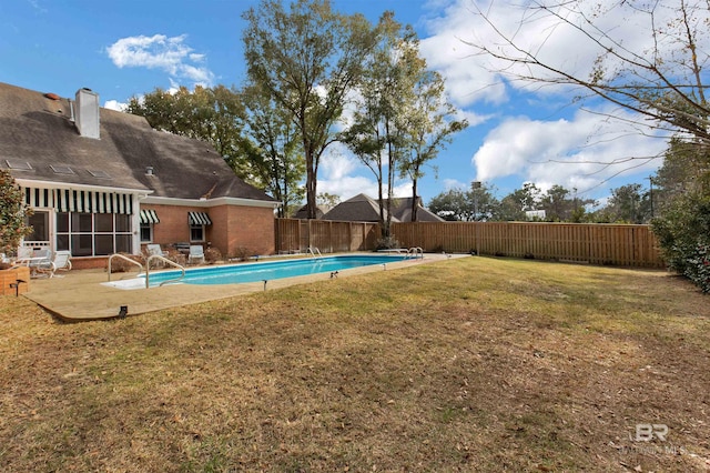 view of pool with a yard and a patio